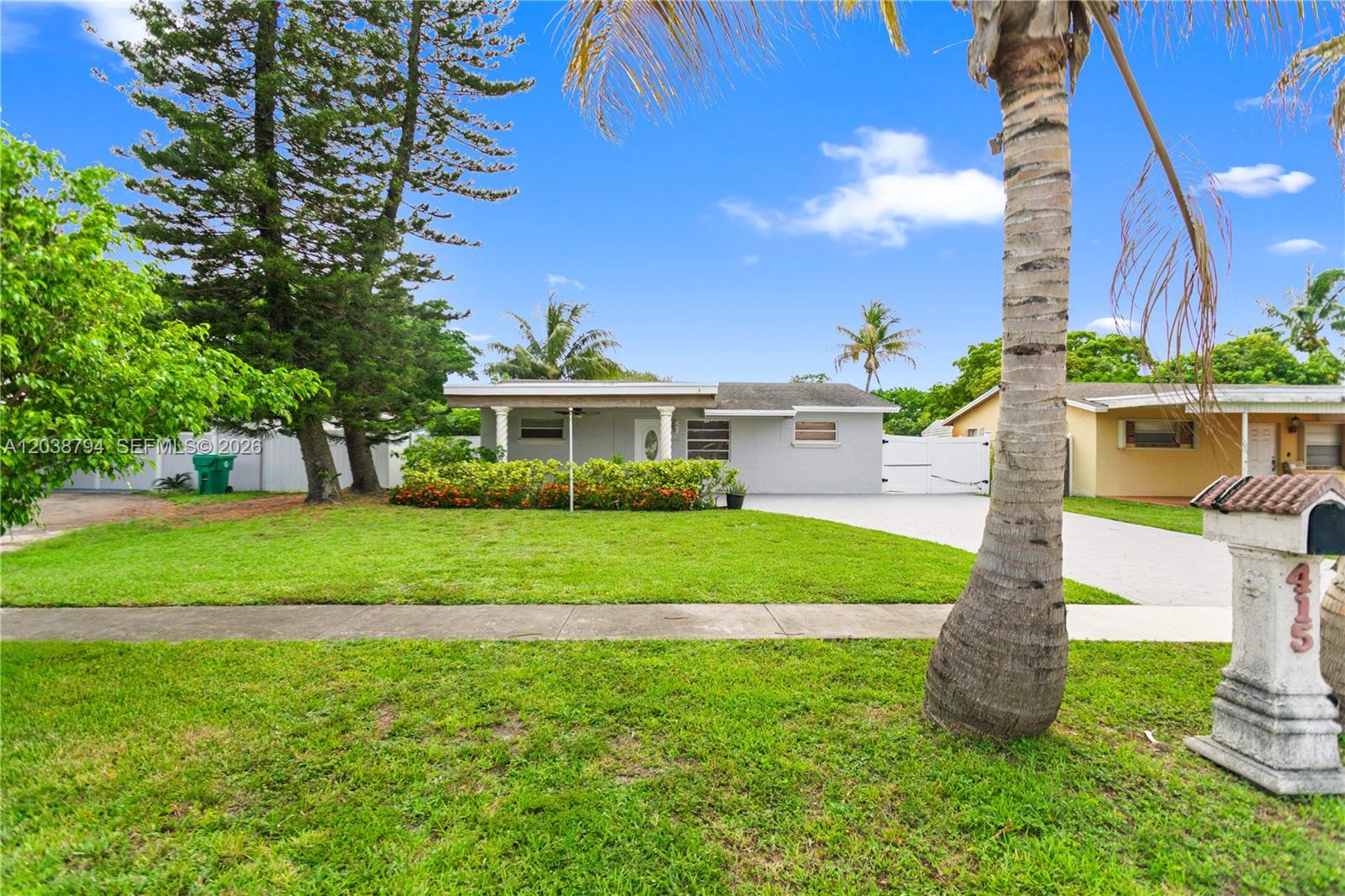 A single-story house with a gray exterior, a paved driveway, and a front lawn — 4151 SW 56th Ave, Davie FL 33314, DAVIE, FL