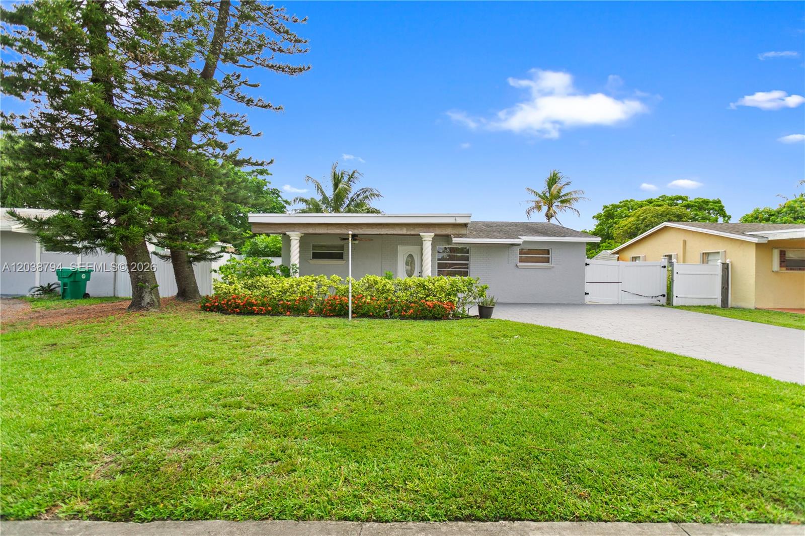 A single-story gray house with a front porch, lawn, and paved driveway — 4151 SW 56th Ave, Davie FL 33314, DAVIE, FL