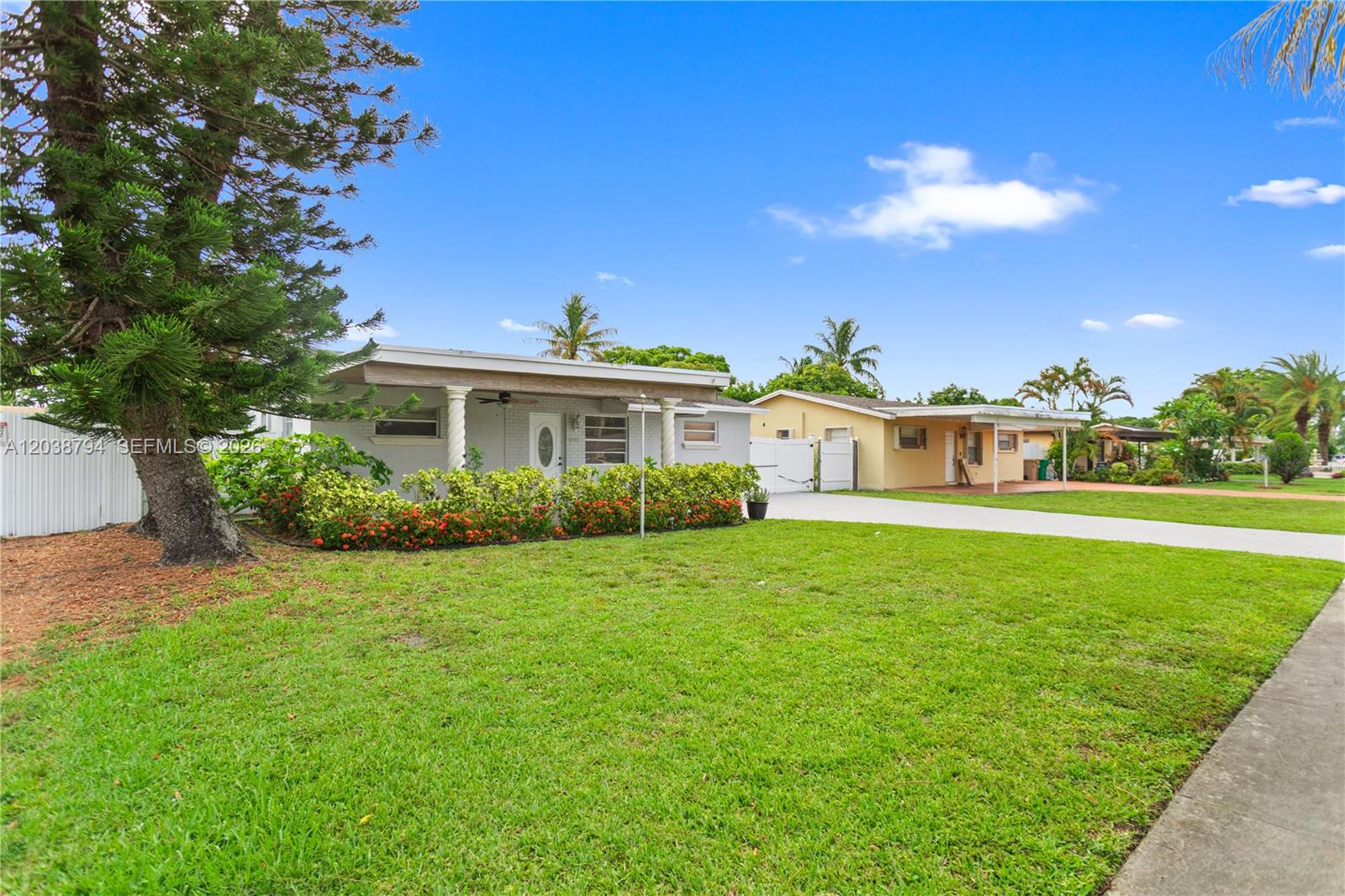A single-story house with a white exterior, a covered porch, and a large front lawn — 4151 SW 56th Ave, Davie FL 33314, DAVIE, FL