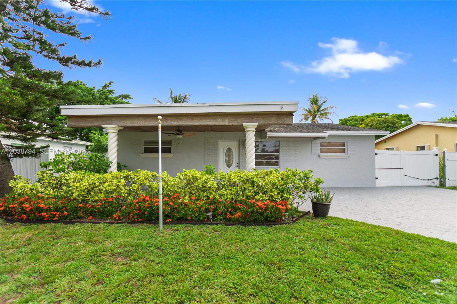 A grey single-story house features a covered front porch with two white spiral columns — 4151 SW 56th Ave, Davie FL 33314, DAVIE, FL