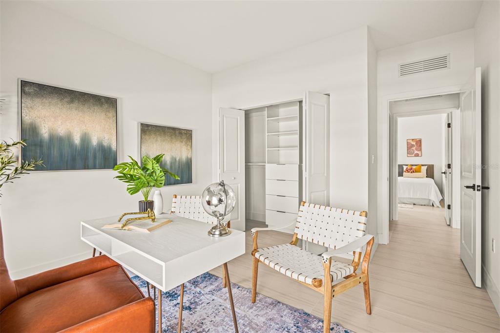 A home office features a white desk, two chairs, a closet, and a view into a bedroom — 6468 QUARTET STREET, MASCOTTE, FL