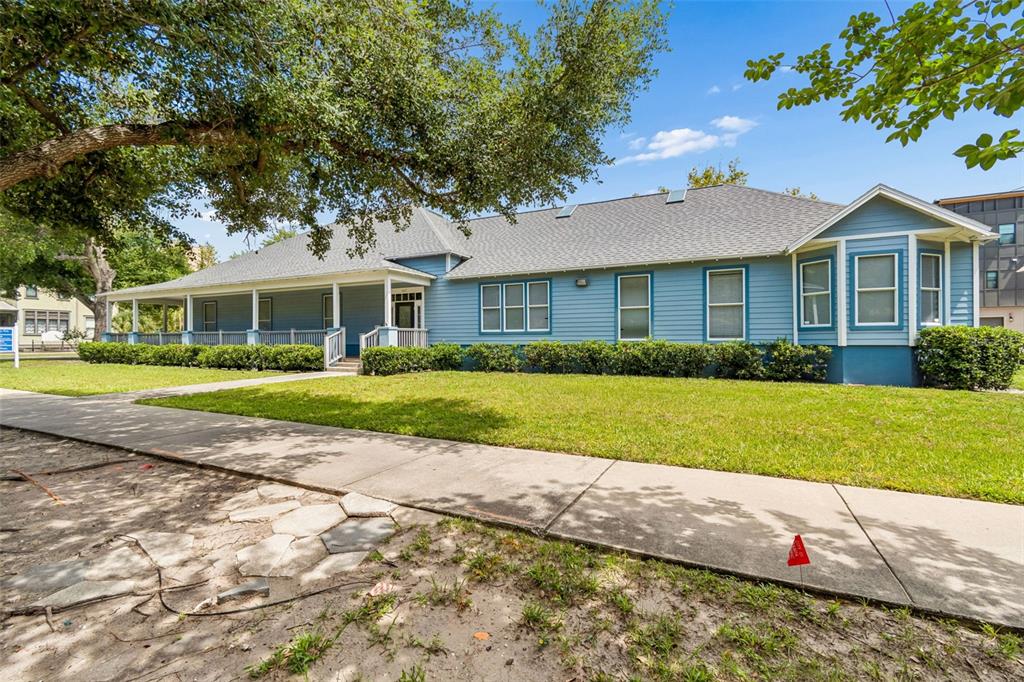A blue single-story house with a wrap-around porch and a bay window — 402 E 7TH AVENUE, TAMPA, FL