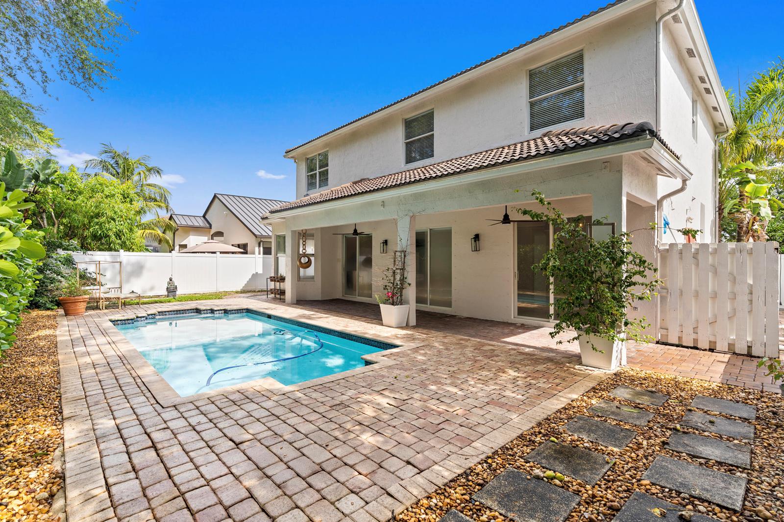 A two-story house with a backyard swimming pool, brick patio, and white privacy fence — 19360 SW 29th Court, Miramar FL 33029, MIRAMAR, FL
