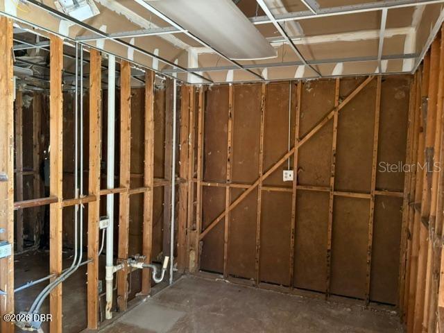 An interior room under renovation features exposed wooden wall studs and a drop ceiling grid — 236 N FREDERICK AVENUE, DAYTONA BEACH, FL