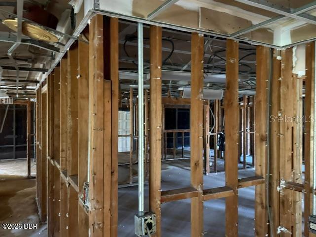 An interior view shows a room under construction with exposed wooden wall studs and framing — 236 N FREDERICK AVENUE, DAYTONA BEACH, FL