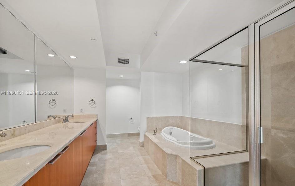 A modern bathroom features a double vanity, a soaking tub, and a glass-enclosed shower — OTHER CITY - IN THE STATE OF FLORIDA, FL