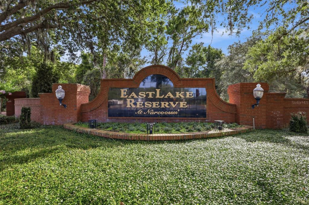 A brick monument sign for EastLake Reserve at Narcoossee stands in a landscaped area — 115 RACHEL LIN LANE, ST CLOUD, FL
