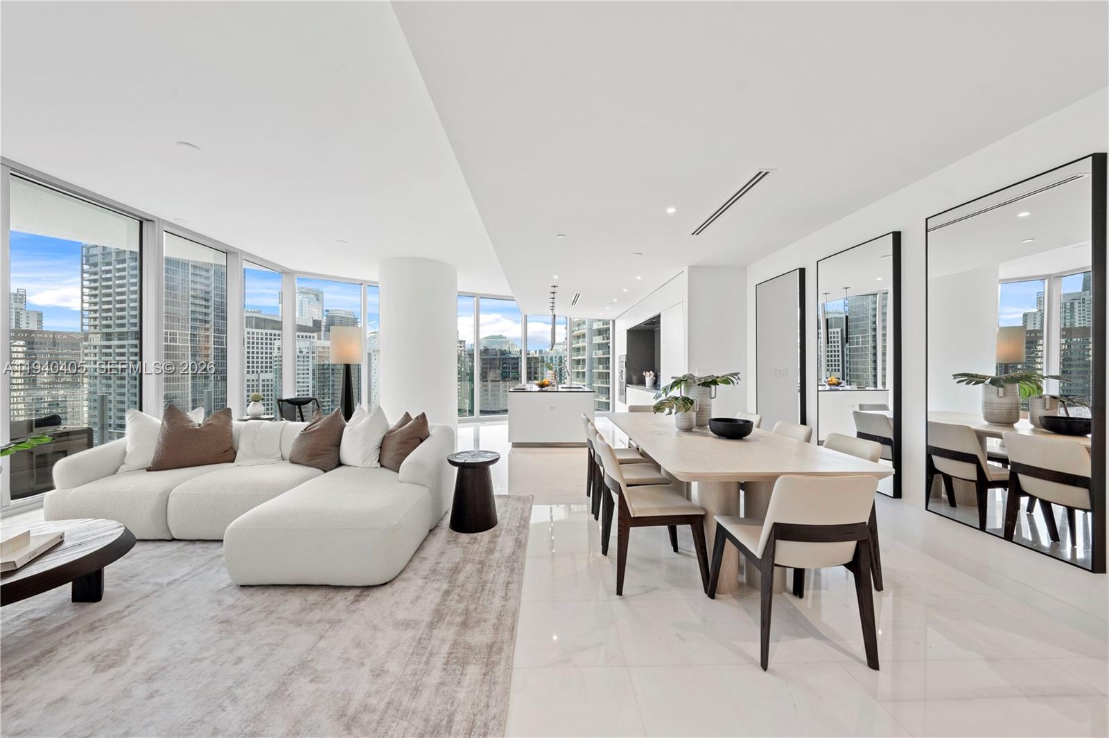 A modern, open-concept living and dining area features white tile floors and floor-to-ceiling windows — 300 Biscayne Blvd Way # 3407, Miami FL 33131, MIAMI, FL