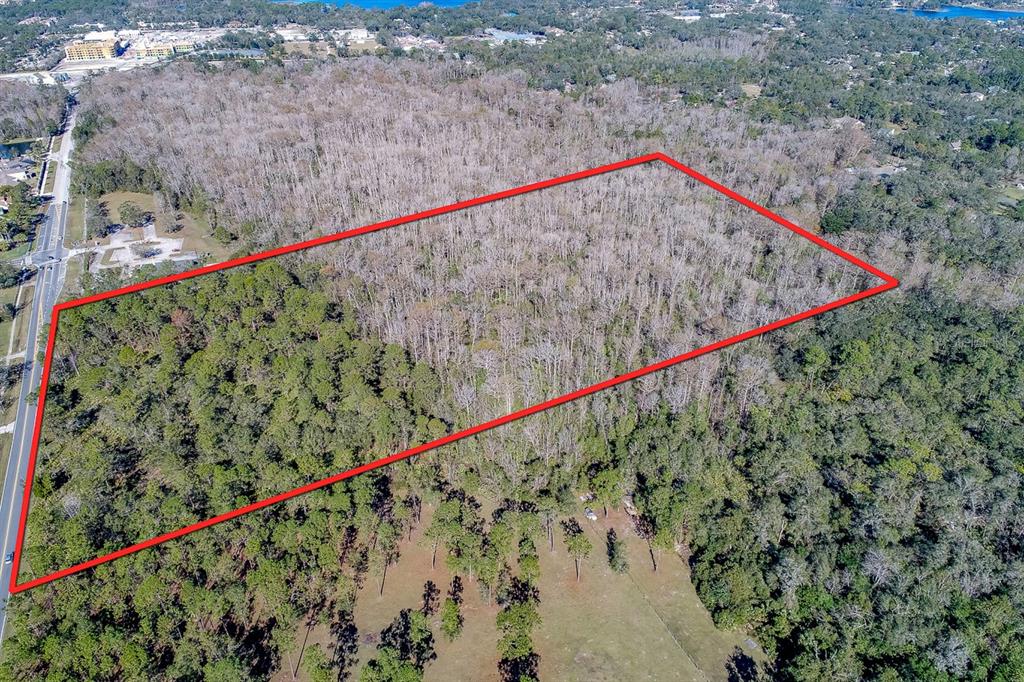 An aerial view shows a large, rectangular plot of wooded land outlined in red — 400 LONGWOOD LAKE MARY ROAD, LAKE MARY, FL