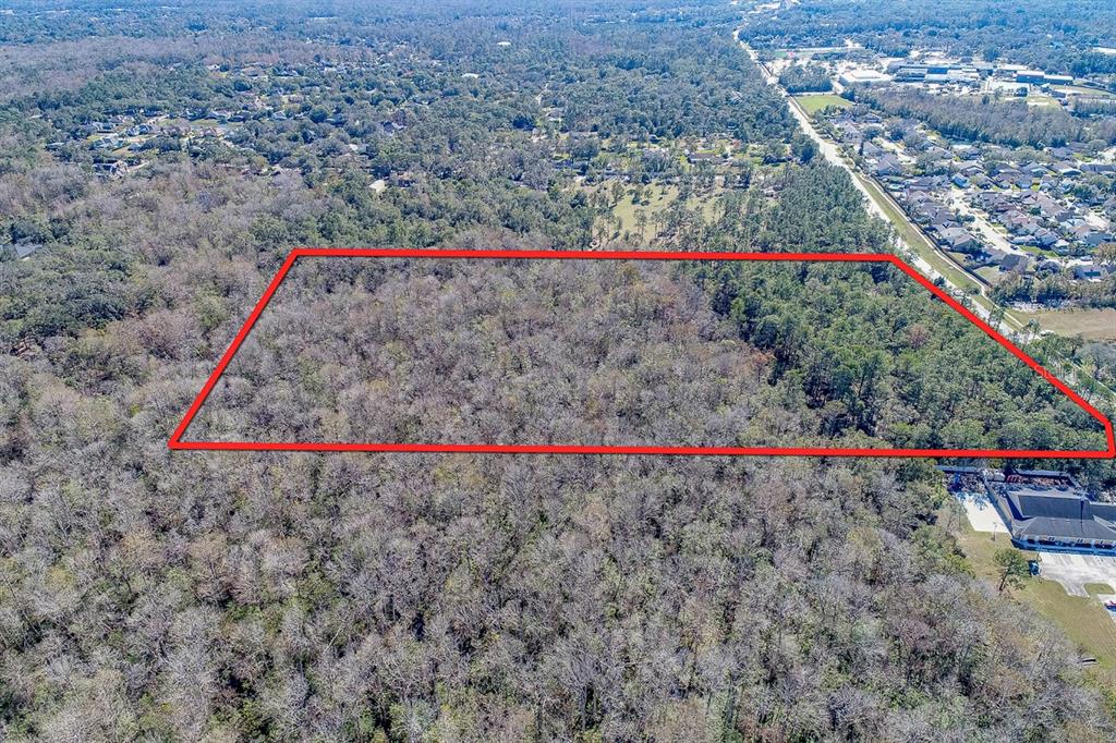 An aerial view shows a rectangular plot of land outlined in red amidst dense forest — 400 LONGWOOD LAKE MARY ROAD, LAKE MARY, FL