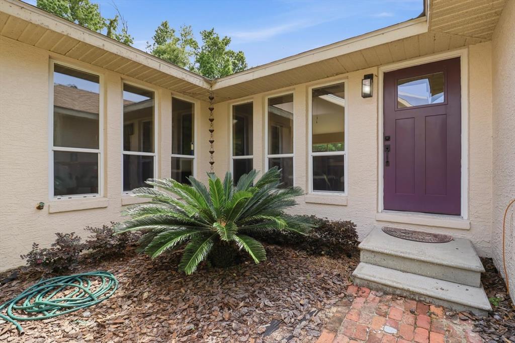 A wide, grassy lot is surrounded by mature trees under a bright, partly cloudy sky — 5900 S MAGNOLIA AVENUE, OCALA, FL