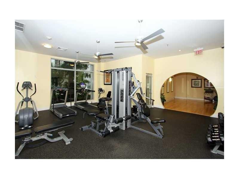 A fitness center with various exercise machines, ceiling fans, and an arched doorway — 1830 Radius Drive # 707, Hollywood FL 33020, HOLLYWOOD, FL