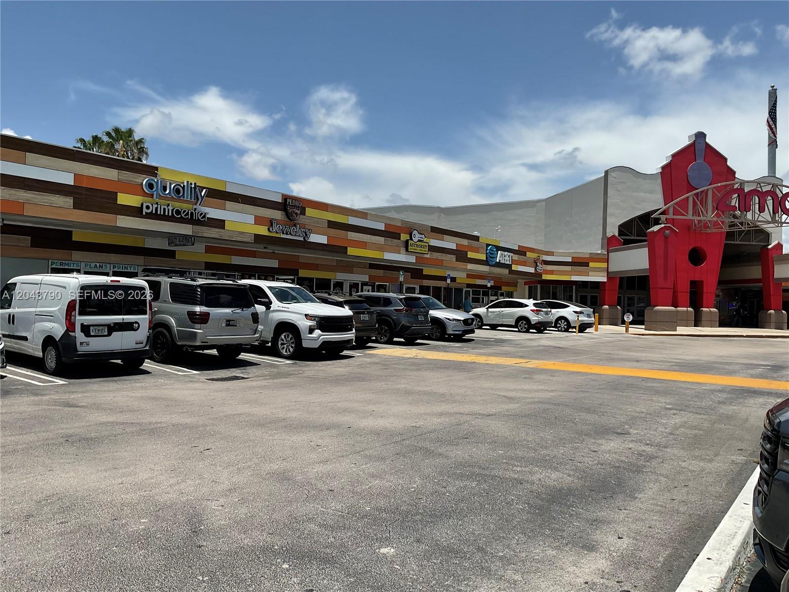 A parking lot sits in front of a strip mall with a red AMC theater entrance — 11865 SW 26th St Unit 43-27, Miami FL 33175, MIAMI, FL