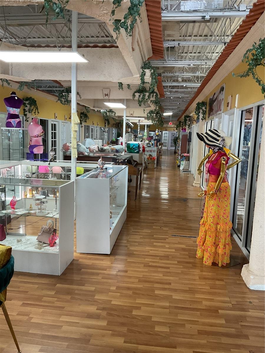 An indoor retail space features glass display cases, mannequins, and wood-look flooring — 11865 SW 26th St Unit 43-27, Miami FL 33175, MIAMI, FL