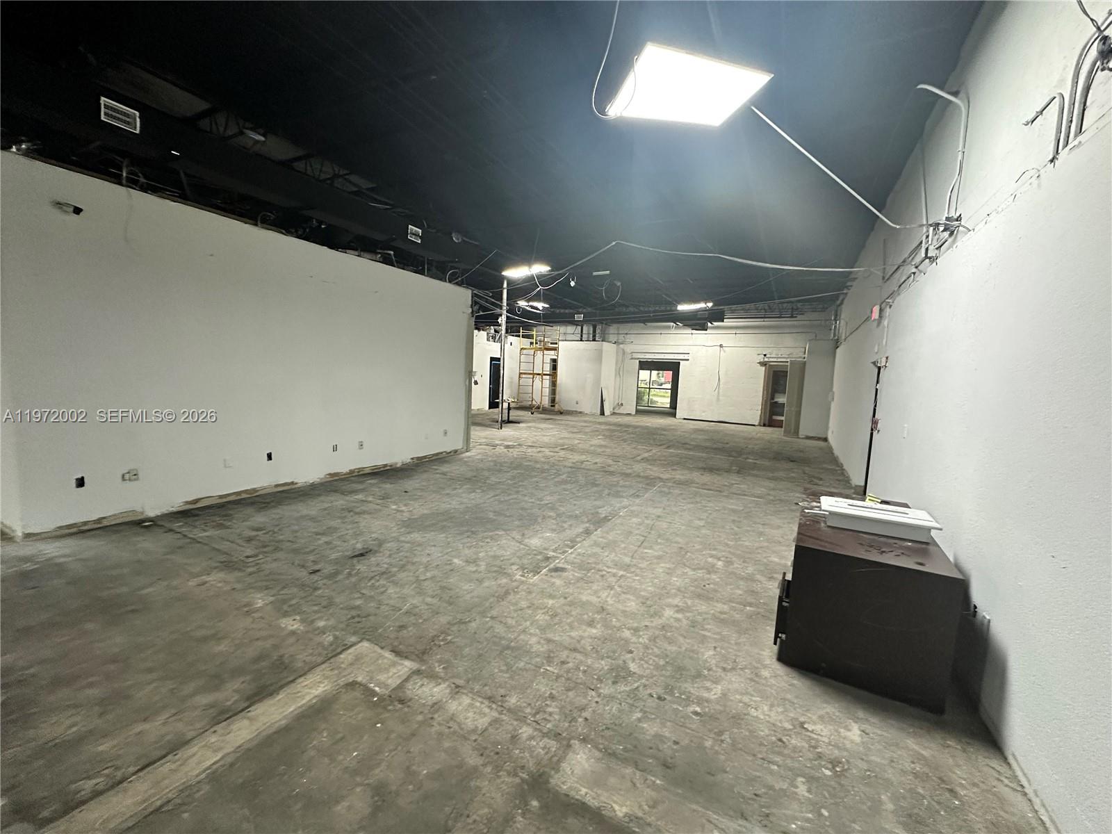 An empty commercial space features white walls, a dark exposed ceiling, and concrete flooring — 2950 N 28th Ter, Hollywood FL 33020, HOLLYWOOD, FL