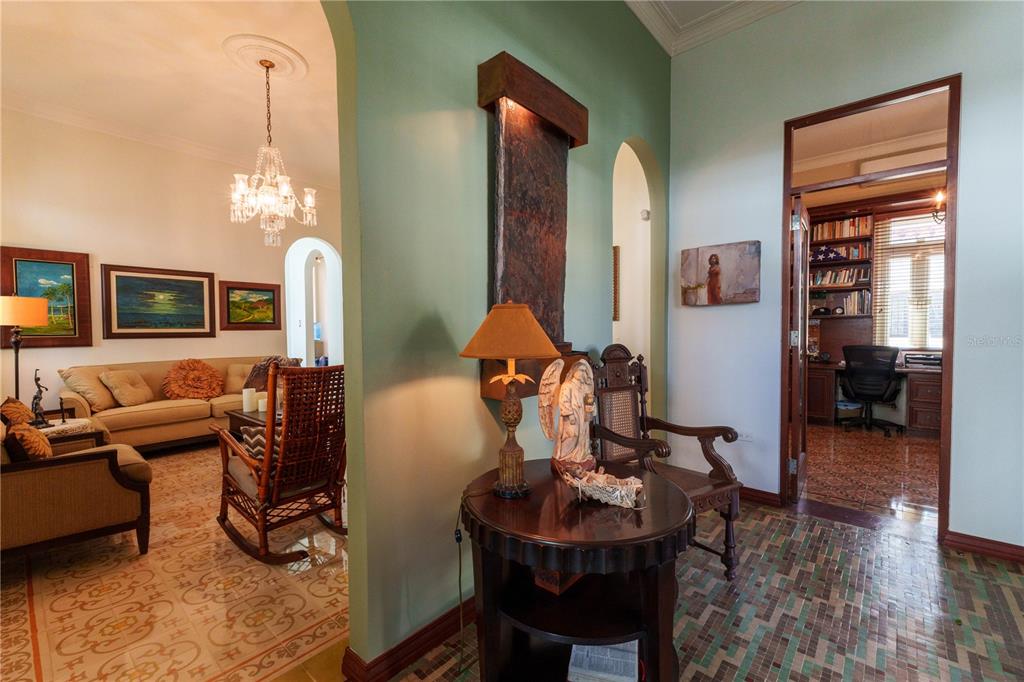 A foyer with a water feature, a round table, and a view into a living room — 655 CONCORDIA, SAN JUAN, PR