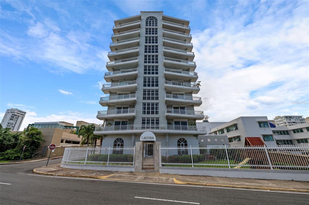 A multi-story residential building named Laguna features stacked balconies and a fenced ground-level entrance — 548 Hoare St. LAGUNA UNIT 3, SAN JUAN, PR