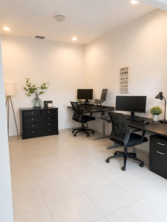 A home office features two desks, black chairs, a black dresser, and wall art — 8205 BAYLISS COURT, ORLANDO, FL