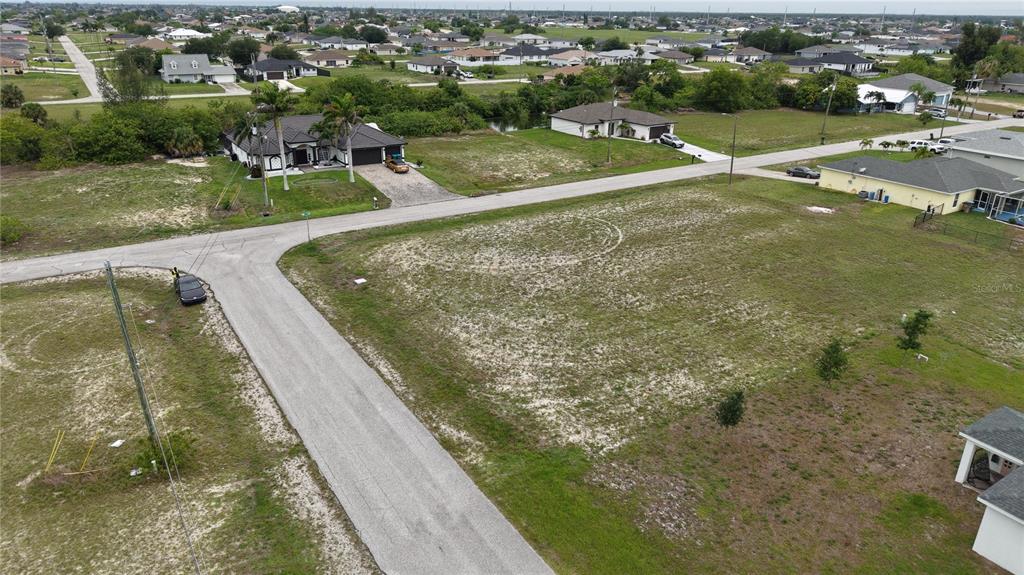 An aerial view shows a vacant residential lot situated at a street corner — 2009 NW 2ND AVENUE, CAPE CORAL, FL