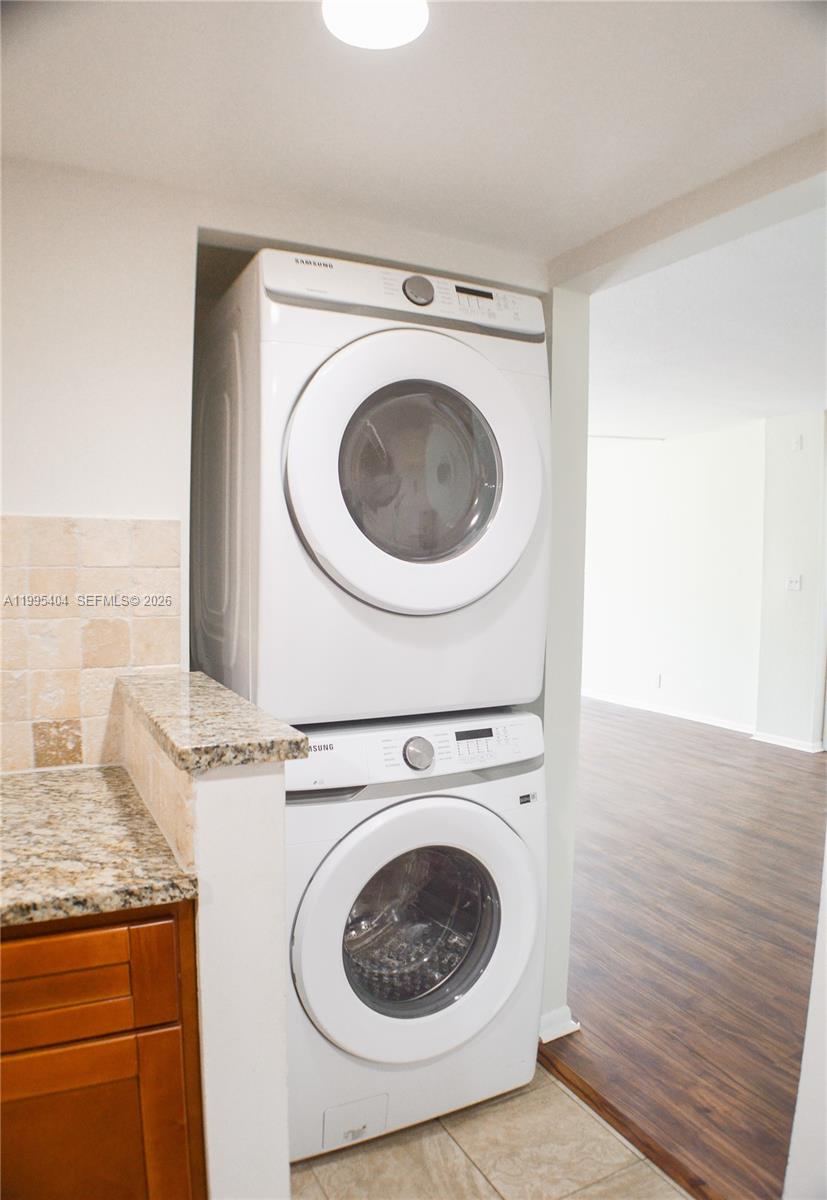 A stacked Samsung washer and dryer unit is installed in a kitchen alcove — 733 SE 1st Way # 206, Deerfield Beach FL 33441, DEERFIELD BEACH, FL