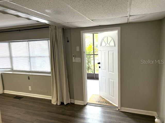 A room with wood-look flooring, a large window with blinds, and an open exterior door — 5200 76TH STREET N, ST PETERSBURG, FL