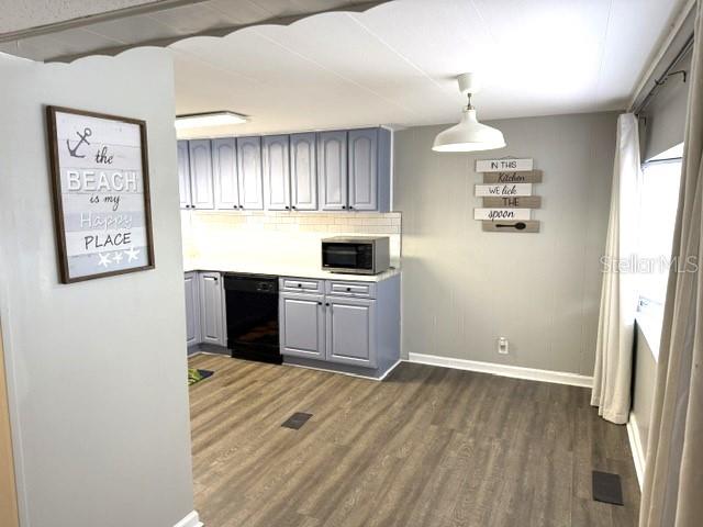 A kitchen features light blue cabinets, a black dishwasher, and wood-look flooring — 5200 76TH STREET N, ST PETERSBURG, FL