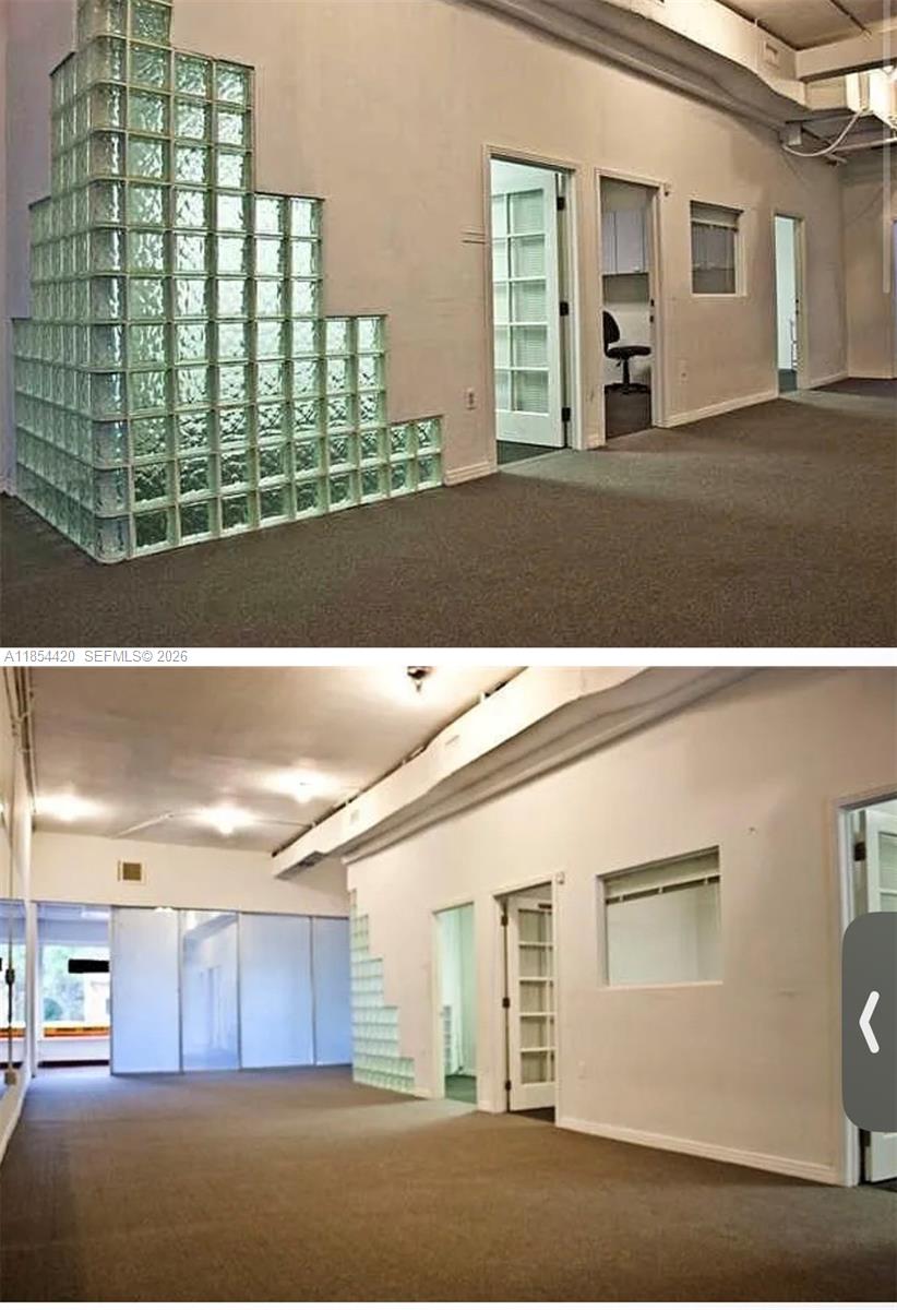 An office space features carpeted floors, white walls, and a tiered glass block partition wall — 710 W 51st St, Miami Beach FL 33140, MIAMI BEACH, FL