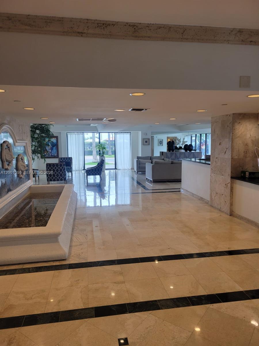 A lobby features a stone fountain, polished tile floors, and a seating area with sofas — 2625 Collins Ave # 1601, Miami Beach FL 33140, MIAMI BEACH, FL