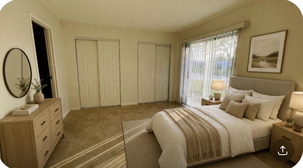 A bedroom with tile floors, two sliding closet doors, and a bed near a window — 166 Valencia G, Delray Beach FL 33446, DELRAY BEACH, FL