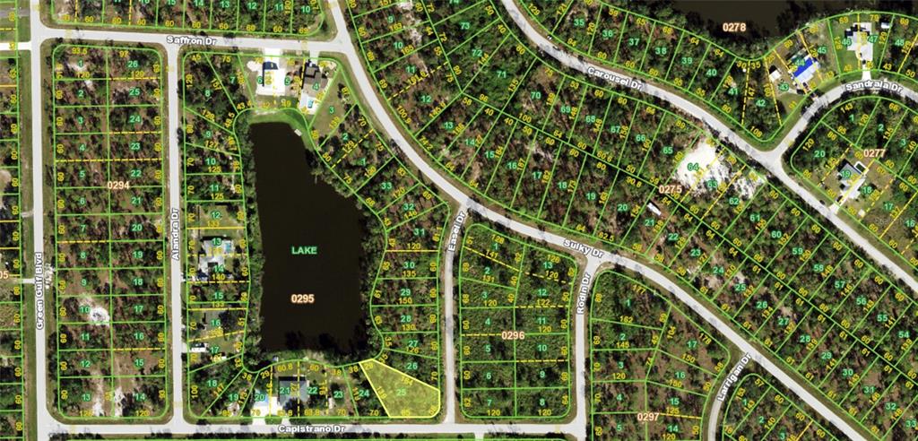 This is a satellite map showing residential lots, streets, and a lake — 27098 CAPISTRANO DRIVE, PUNTA GORDA, FL