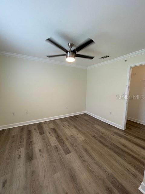 An empty bedroom features light-colored walls, a ceiling fan, and wood-look flooring — 18319 BRIDLE CLUB DRIVE, TAMPA, FL