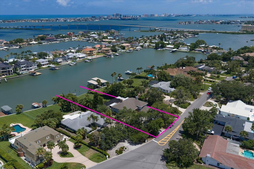 An aerial view shows a waterfront residential property outlined in pink along a canal — 220 HARBOR VIEW LANE, LARGO, FL