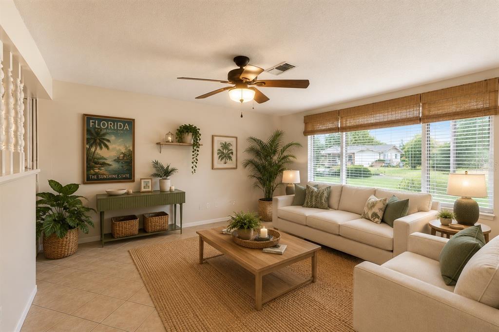 A living room features a beige sofa, a wooden coffee table, and a Florida wall poster — 7203 CHERRY LAUREL DRIVE, PORT RICHEY, FL