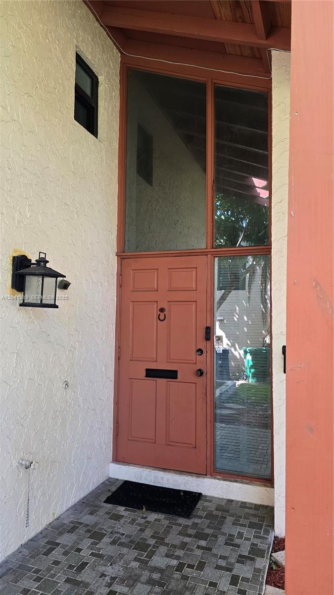 A front entrance features a terracotta-colored door with a sidelight and transom window — 3412 Spring Bluff Pl # 43, Lauderhill FL 33319, LAUDERHILL, FL