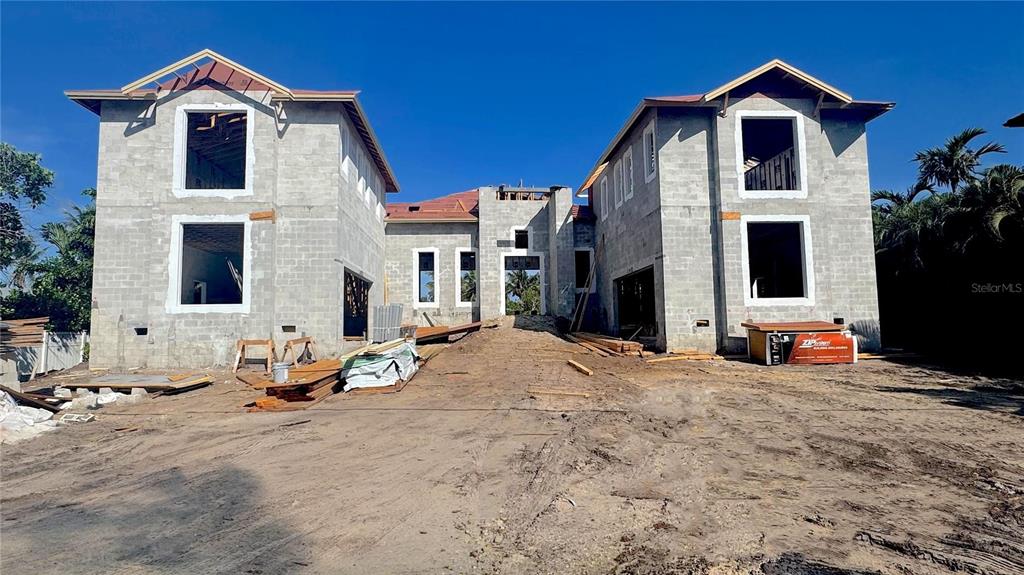 A two-story concrete block house under construction with a central entrance and roof framing — 3441 GULFMEAD DRIVE, SARASOTA, FL