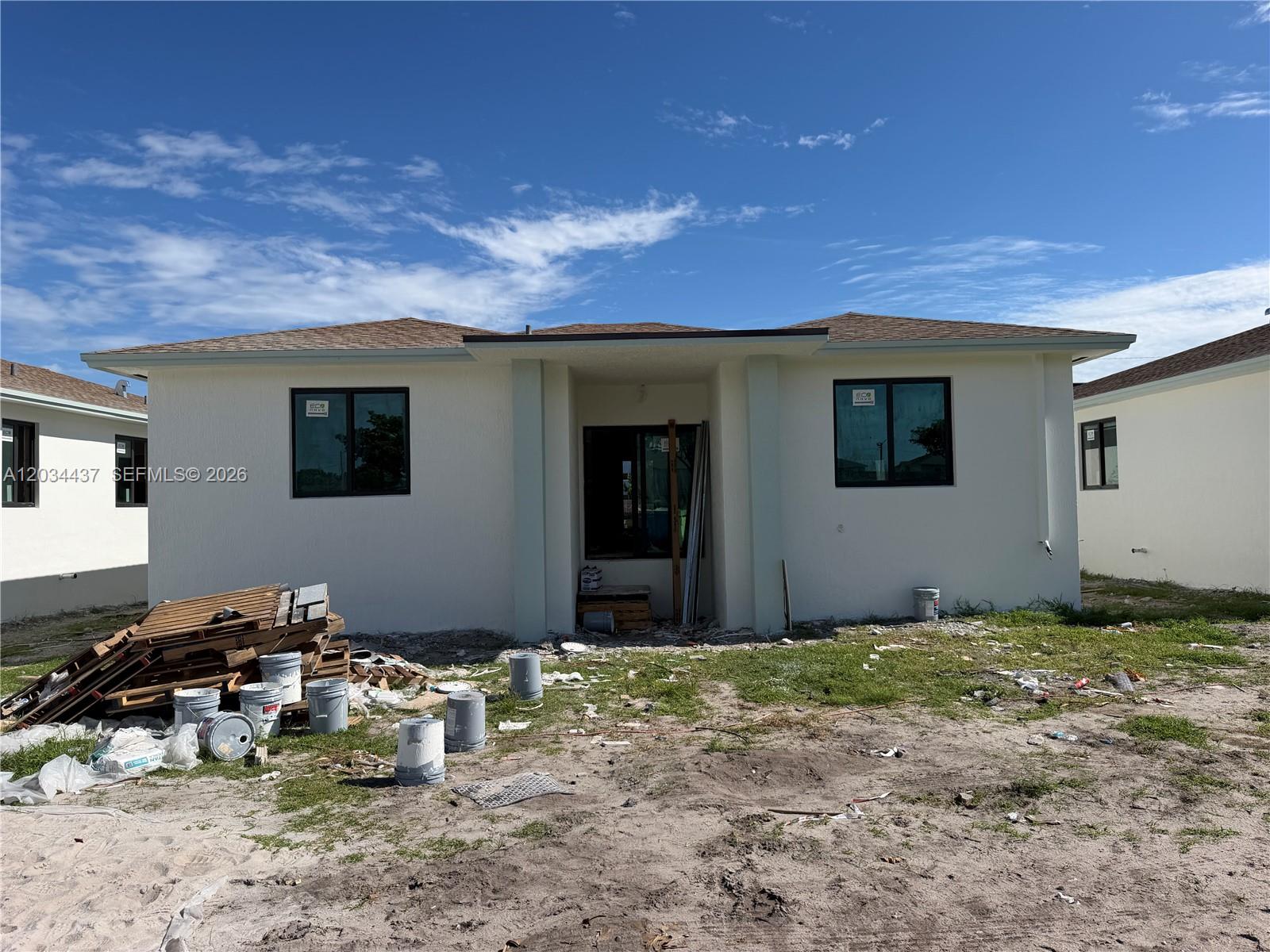 A newly constructed single-story house exterior features white stucco walls and a brown shingled roof — 340 NW 11th St, Pompano Beach FL 33060, POMPANO BEACH, FL