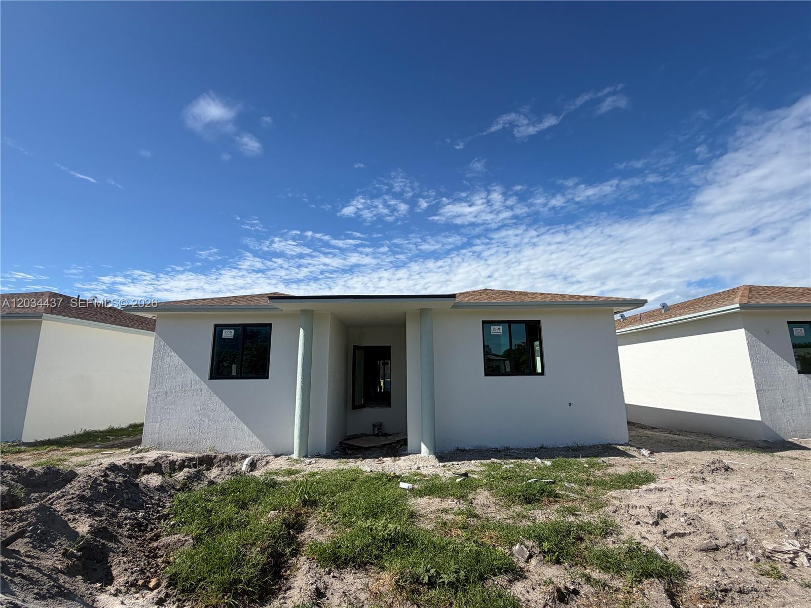 A newly constructed, single-story white house with a recessed entrance and two front windows — 340 NW 11th St, Pompano Beach FL 33060, POMPANO BEACH, FL