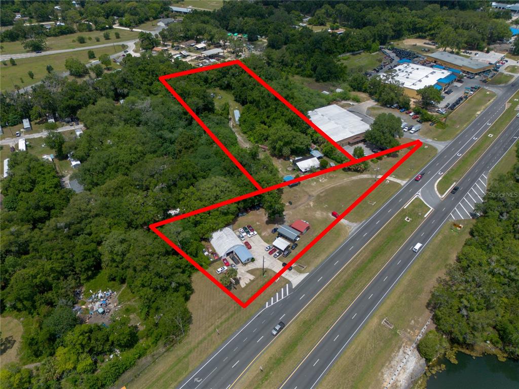 An aerial view shows two adjacent parcels of land outlined in red along a highway — 3728 N US HIGHWAY 441, OCALA, FL