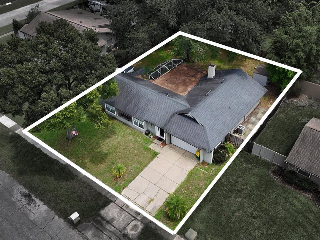 An aerial view shows a single-story house with a shingled roof and a concrete driveway — 1792 PAM CIRCLE, ORLANDO, FL