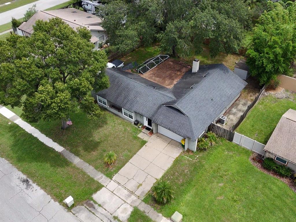 An aerial view shows a single-story house with a dark roof, garage, and backyard patio — 1792 PAM CIRCLE, ORLANDO, FL