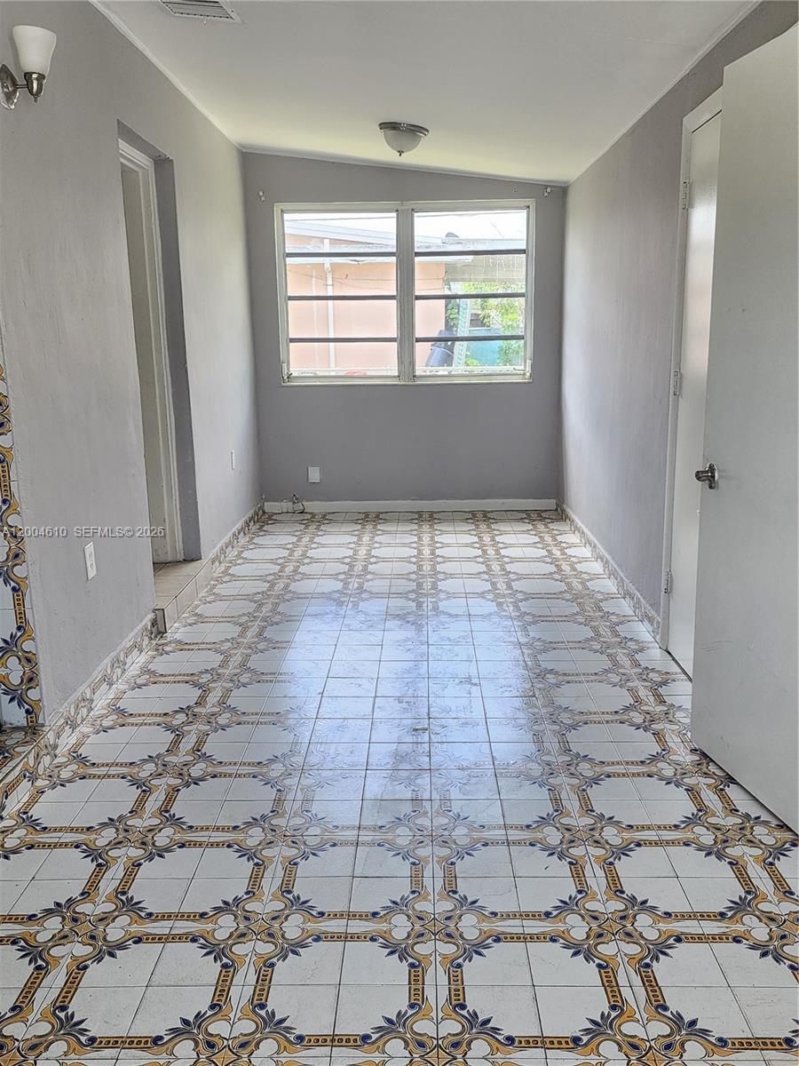A narrow room features patterned tile flooring, gray walls, and a large window — 4100 SW 36th St, West Park FL 33023, WEST PARK, FL