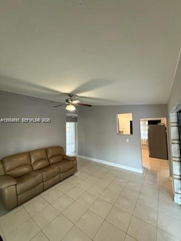 A living room features light-colored tile flooring, a tan leather sofa, and a ceiling fan — 4100 SW 36th St, West Park FL 33023, WEST PARK, FL