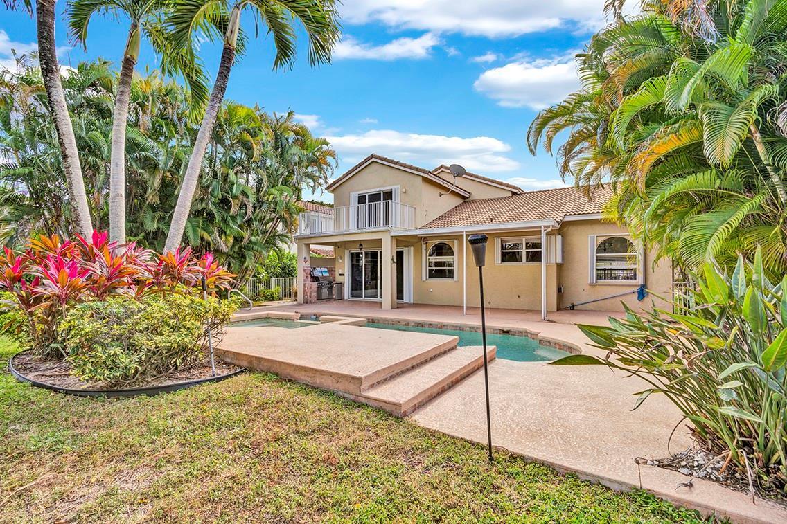 A two-story house with a backyard pool, patio, and lush tropical landscaping — 19571 Black Olive Lane, Boca Raton FL 33498, BOCA RATON, FL