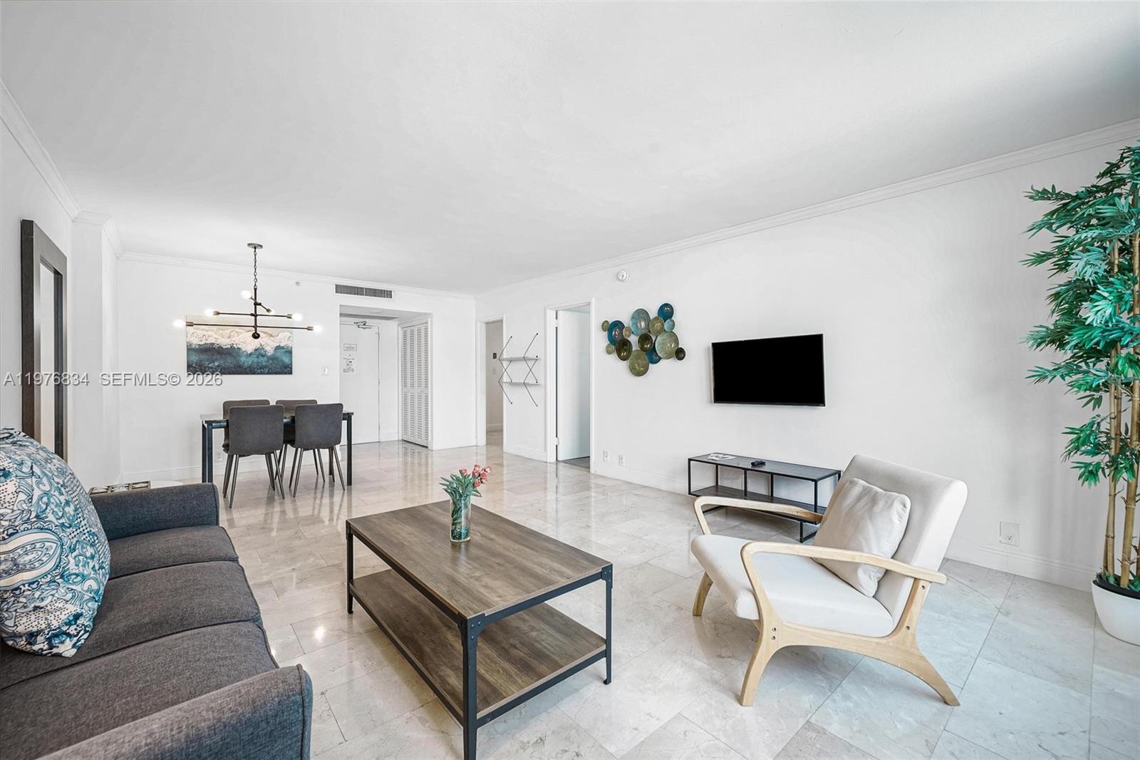 A living and dining area features white walls, tile floors, and modern furniture — 5101 Collins Ave # 11L, Miami Beach FL 33140, MIAMI BEACH, FL
