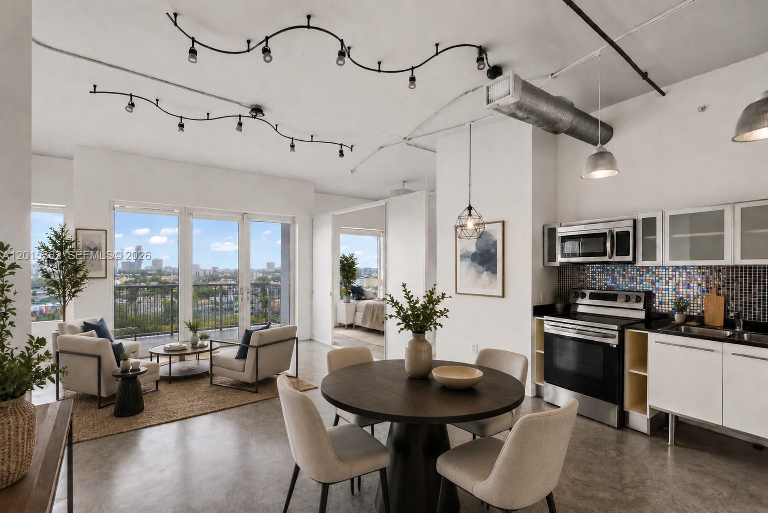 An open-concept apartment features a kitchen, dining area, living space, and a balcony with city views — 10 SW South River Dr # 1006, Miami FL 33130, MIAMI, FL