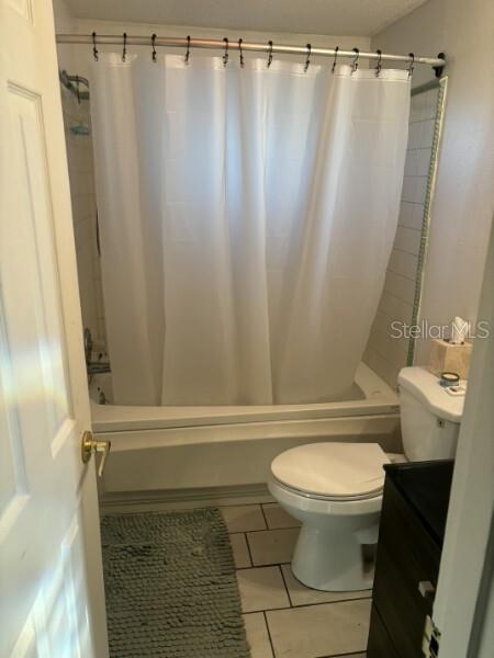 A bathroom features a white shower curtain, a toilet, and light-colored floor tiles — 4801 AVON STREET, LAKE WALES, FL