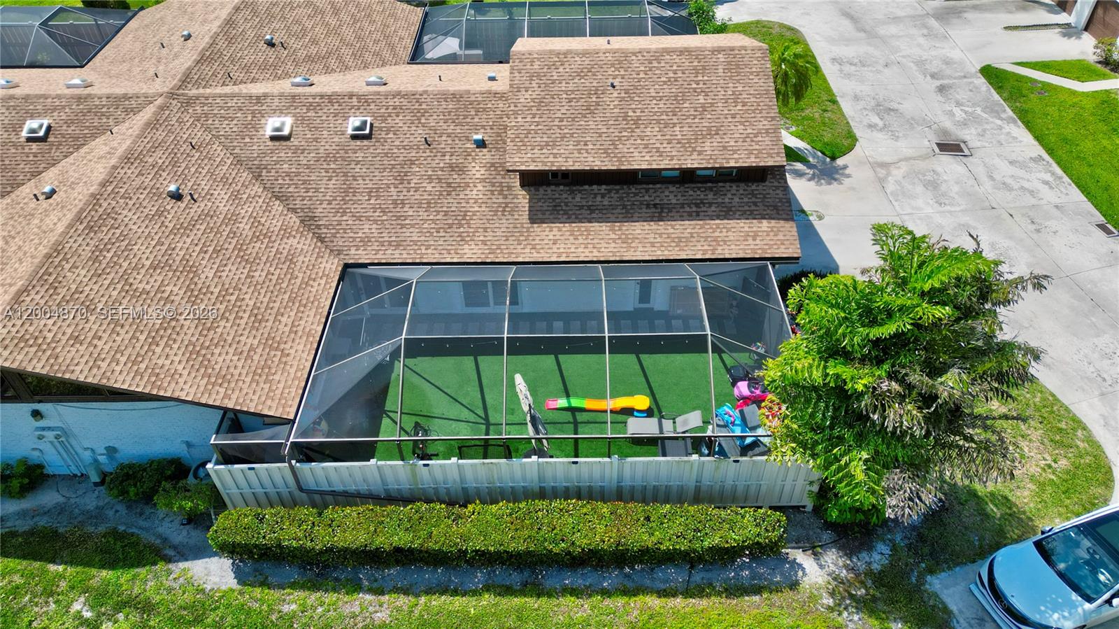 An aerial view shows a house with a shingled roof and a screened-in patio area — 9604 Boca Gardens Pkwy # A, Boca Raton FL 33496, BOCA RATON, FL