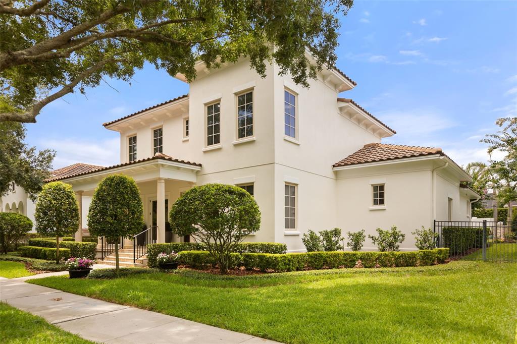 A two-story stucco house with a tiled roof and landscaped front yard — 2656 MEETING PLACE, ORLANDO, FL