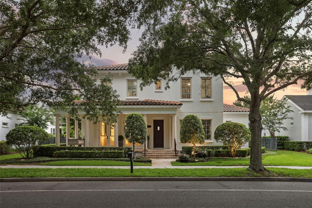 A two-story white stucco house with a tiled roof and a front porch — 2656 MEETING PLACE, ORLANDO, FL