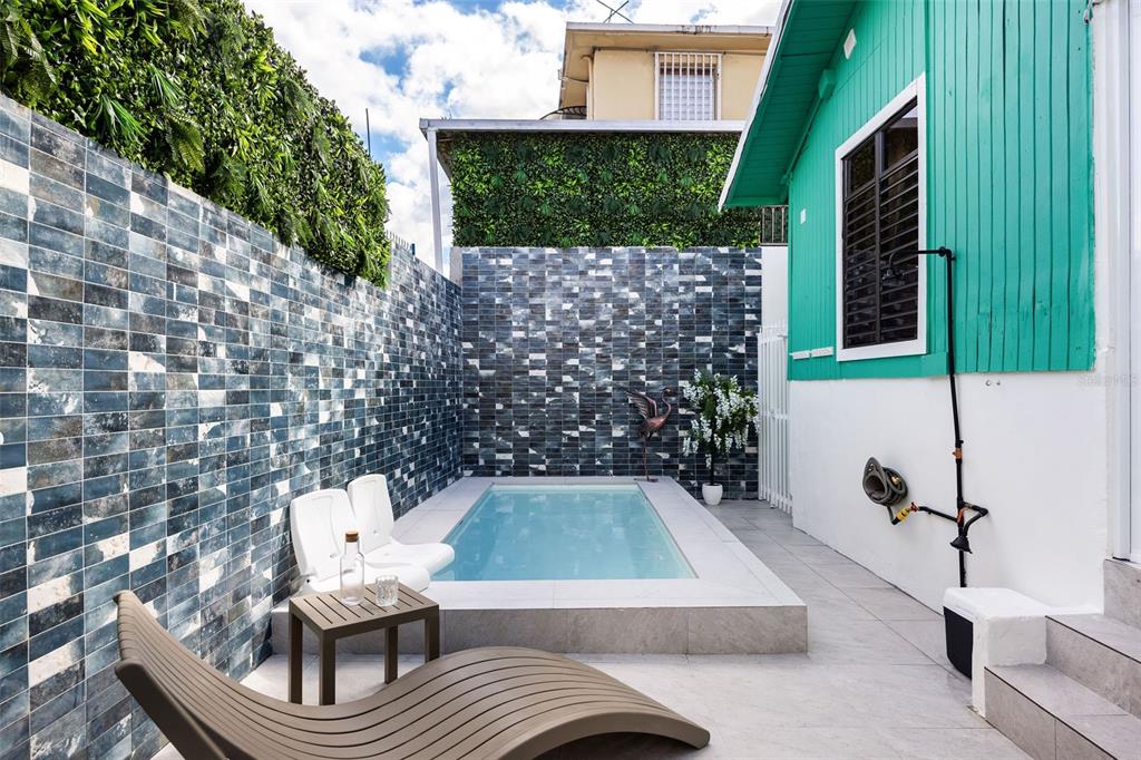 A small rectangular pool sits in a courtyard with tiled walls and a lounge chair — 115 SANTA CECILIA, SAN JUAN, PR